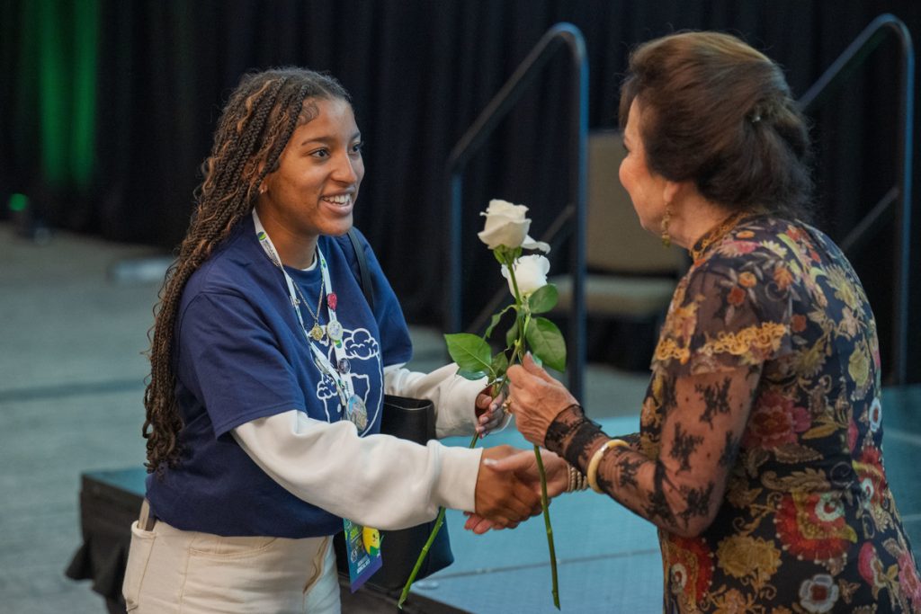 global youth institute member receiving a rose